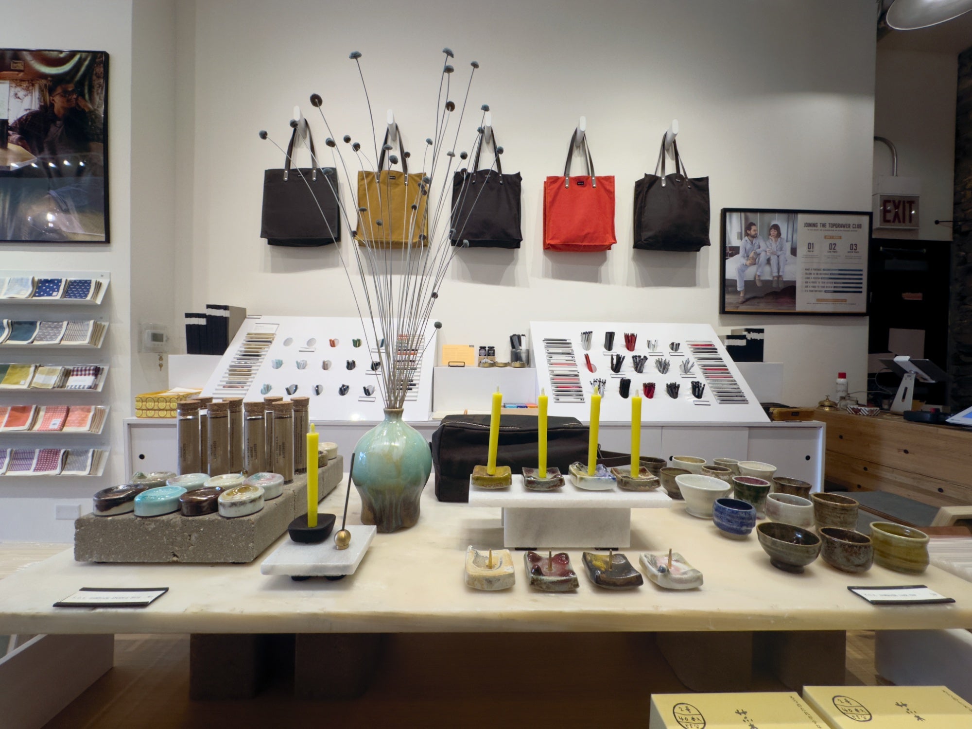 Table display at topdrawer showcasing clay art of Kevin John OKeefe. It highlights his sake cups, incense holders, and candle holders.